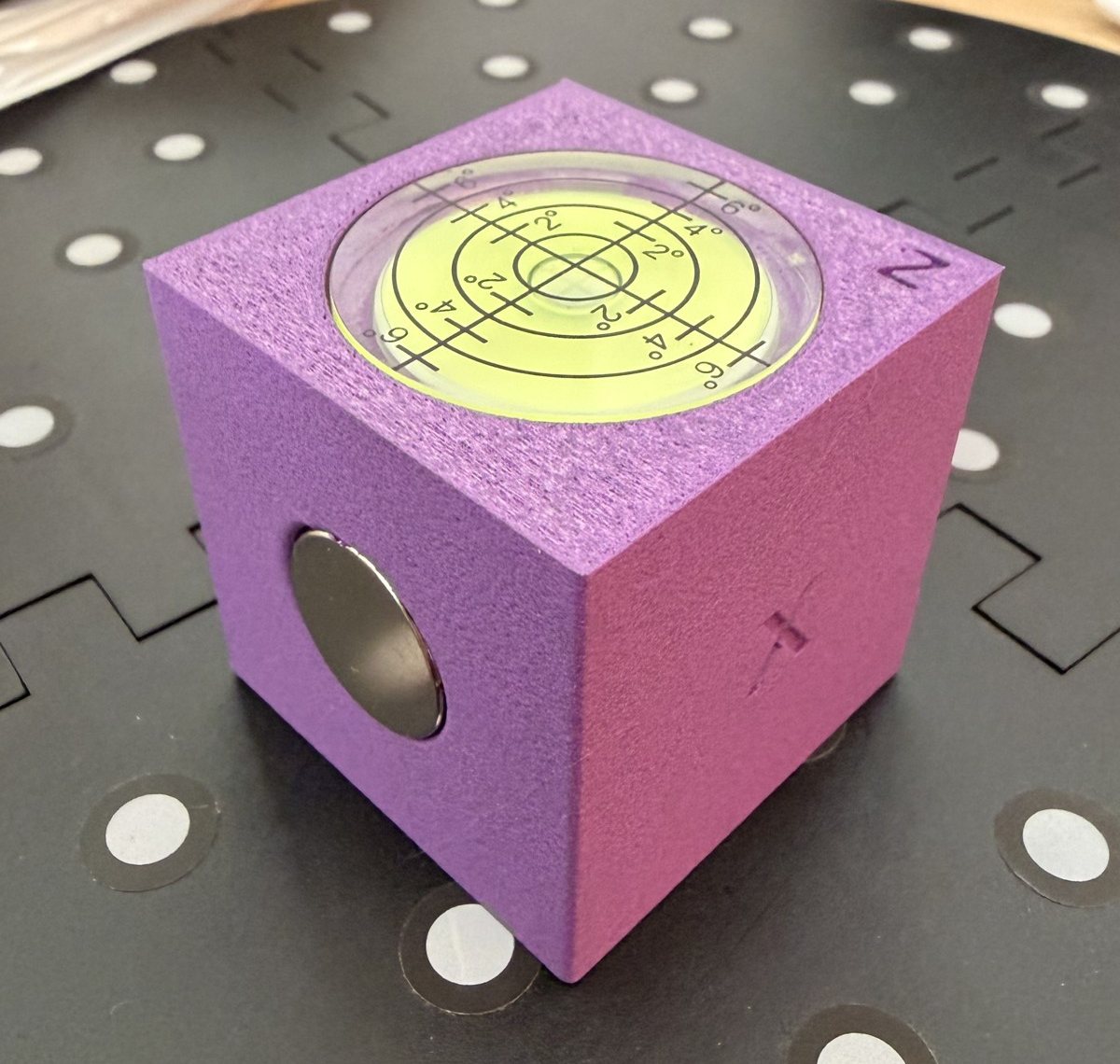 Purple 3D printed level block with graduated bubble level on top and flush magnet on the side