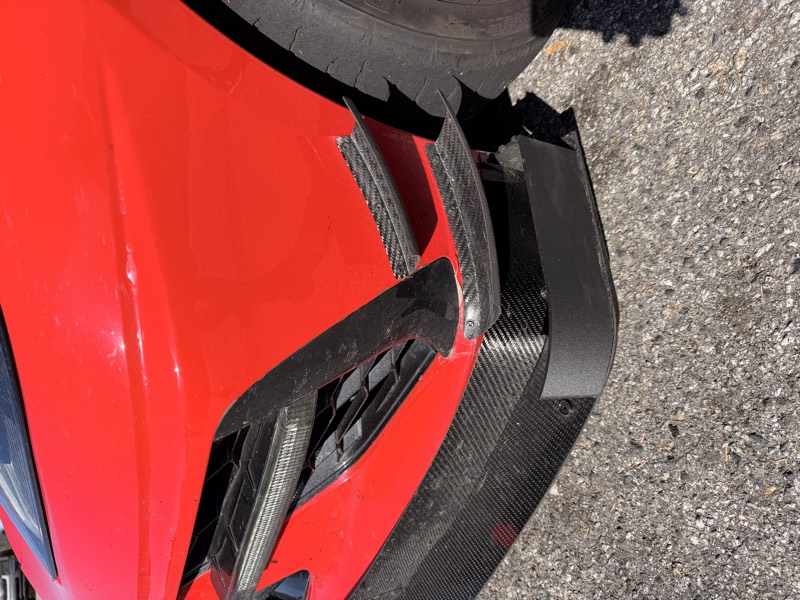 Carbon splitter endplate on the red C8 front corner